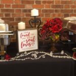 A buffet table with a sign that reads 'love is in the air'.