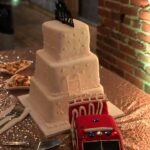 A wedding cake with a fire truck on it.