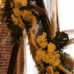 A wedding arch decorated with flowers and greenery.