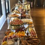 A buffet table with a lot of food on it.