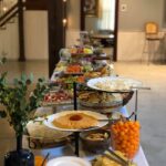 A buffet table with a lot of food on it.