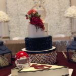 A wedding cake with a football helmet on top.