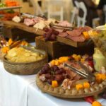 A buffet with a variety of meats and cheeses.