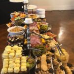 A buffet table with a variety of snacks and desserts.