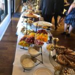 A long buffet table with a lot of food on it.