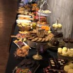 A dessert table with a variety of desserts on it.