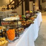 A buffet table with a lot of food on it.