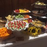 A buffet table with a variety of food on it.