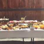 A buffet table with a lot of food on it.