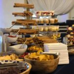 A buffet table with a variety of snacks and desserts.