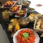 A buffet table with a variety of food on it.