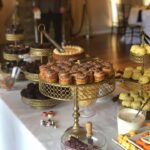 A buffet table with a variety of desserts and snacks.