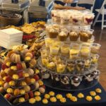 A buffet table with a variety of desserts on it.