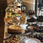 A buffet table with a variety of desserts on it.