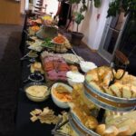 A buffet table with a variety of food on it.