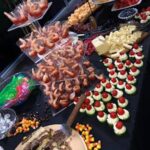 A buffet table with a variety of snacks and desserts.