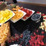 A buffet of fruits and vegetables on a table.