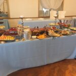 A buffet table with a lot of food on it.