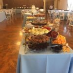 A buffet table with a variety of pastries and desserts.