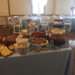 A buffet table with a variety of foods and desserts.