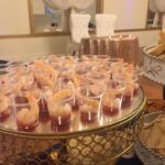 A tray of appetizers on a table at a wedding.