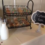 A table with milk, cereal, and a chalkboard sign.