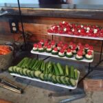 A tray of fruit and vegetables on a table.