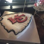 A cake with a kansas city chiefs logo on it.