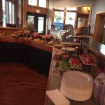 A buffet table with a lot of food on it.