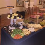 A buffet table with a variety of food on it.