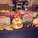 A buffet table with a variety of food on it.