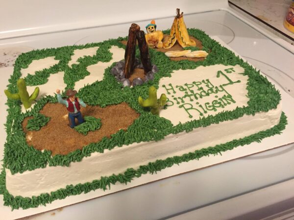 A birthday cake decorated with a teepee and a teepee.