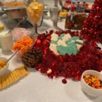 A table full of food and decorations for a christmas party.