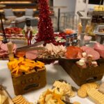 A buffet of meats and cheeses on a table.