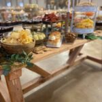 A buffet table with a variety of food on it.