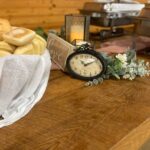 A table with bread and a clock on it.