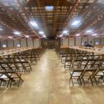 A large room with rows of chairs and lights.