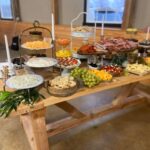 A buffet table with a variety of food on it.