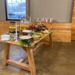 A wooden table with a variety of food on it.