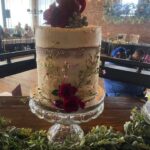 A wedding cake is sitting on top of a table.