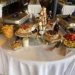 A buffet table with a variety of food on it.