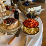 A buffet of fruit and desserts on a table.