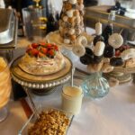 A buffet table with a variety of food and desserts.