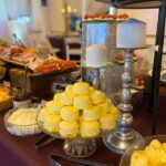 A buffet table with a variety of food on it.