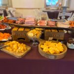 A buffet table with a variety of foods on it.