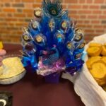 A peacock shaped cake on a table.