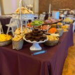 A buffet table with a variety of food on it.