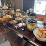 A buffet table with a lot of food on it.