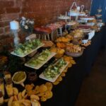 A buffet table with a variety of food on it.