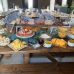 A buffet table with a variety of food on it.